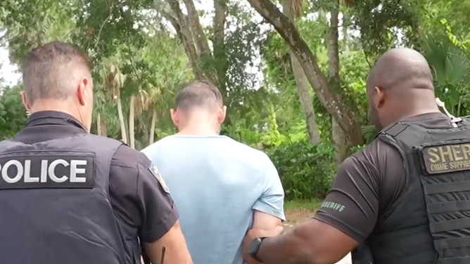Gardner being arrested.